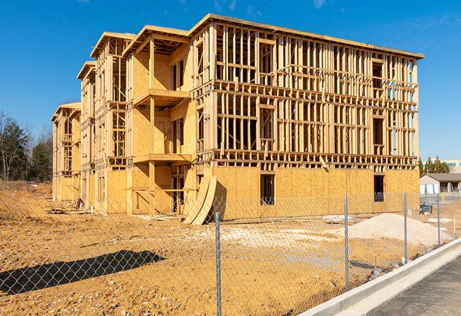 a construction site enclosed by temporary chain link fences, ensuring safety for workers and pedestrians in Weir, TX